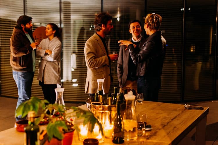 Several people celebrating the new year at a holiday dinner party.