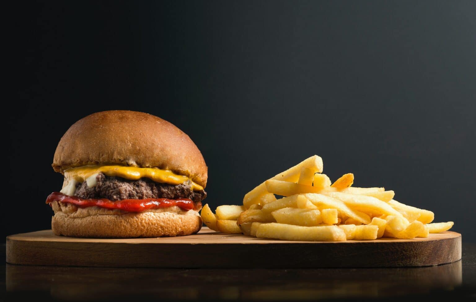 A cheeseburger and fries on a plate.