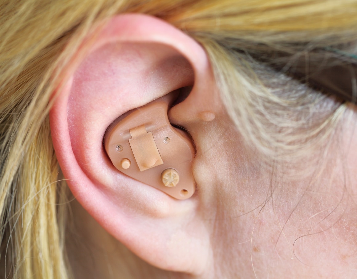 Close-up of a hearing aid in someone's ear.