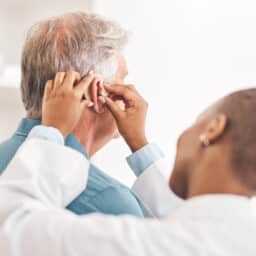 Man being fit with a hearing aid