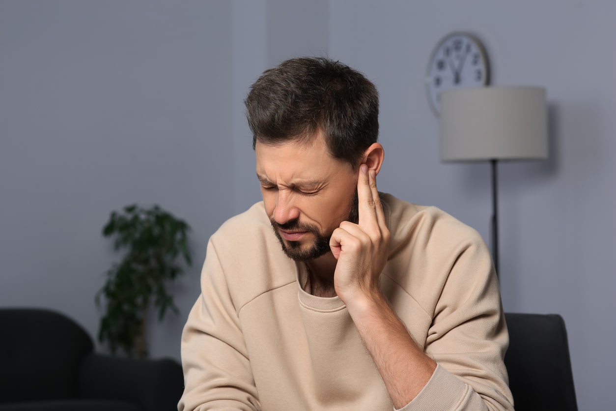 Man being fit with a hearing aid.